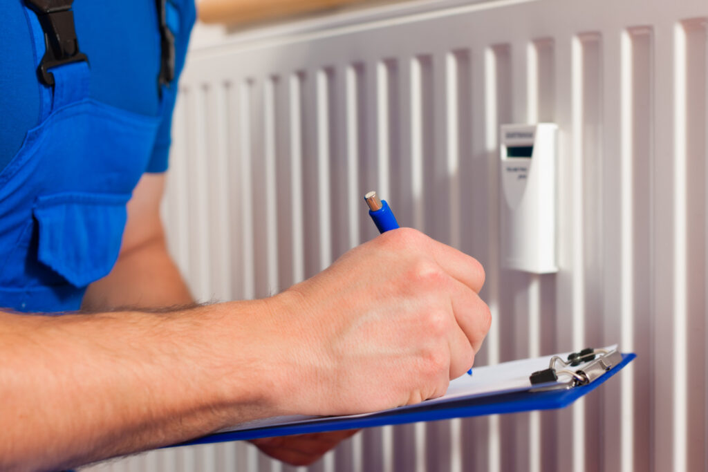 A technician is inspecting a HVAC Unit